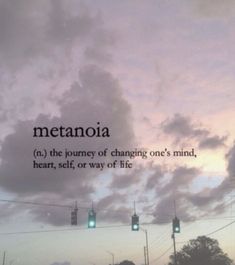 the sky is filled with clouds and green traffic lights that read, metanoia