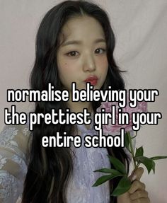 a girl with long black hair holding a flower and texting normalise believing your the prettiest girl in your entire school