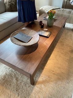 a coffee table with a book on it in a living room