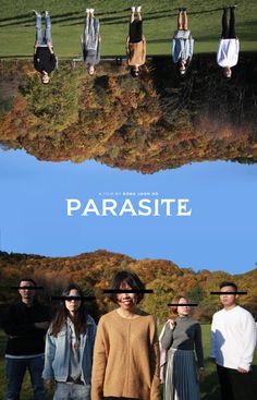 people standing in front of a blue sky with the words parasite on it