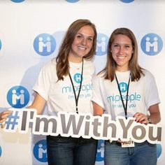 two women holding up a sign that says i'm in with you