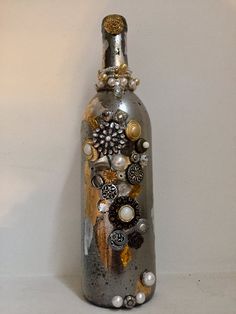 a bottle that has buttons and other things on the top of it, sitting against a wall