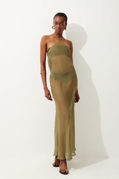 Crafted For Poolside Styling, This Semi-Sheer Maxi Beach Dress Cascades With An Elegant Quality That Will Maximise Your Bikini Styling. Framing The Form With An Angled Halter Neck, This Style Lands At A Gathered Hem With Split Sides.Halter Neckmesh Bodysplit Sidesmaxi Hem Fitted Halter Neck Maxi Dress For Beach Cover-up, Green Halter Neck Beach Dress Cover-up, Sheer Maxi Dress For Summer Beach Cover-up, Beach Cover-up Maxi Dress With Halter Neck, Beach Cover-up Maxi Length Halter Sundress, Bathing Suit Dress, Halter Maxi, Beach Maxi Dress, Khaki Dress