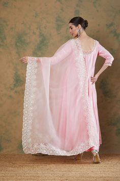 The baby pink embroidered anarkali set features exquisite thread and mirror embroidery on its neckline and sleeves with cutwork details. The anarkali comes with a beautiful flair and is paired with a baby pink embroidered silk organza dupatta. Pink Anarkali Set With Gota Work For Eid, Pink Anarkali Kurta With Sheer Dupatta, Pink Lace Work Straight Kurta Sets, Pink Straight Kurta Set With Lace Work, Pink Chanderi Lace Work Sets, Pink Anarkali Set With Chikankari Embroidery, Pink Organza Churidar With Traditional Drape, Pink Organza Kurta With Gota Work, Pink Chanderi Churidar With Sheer Dupatta