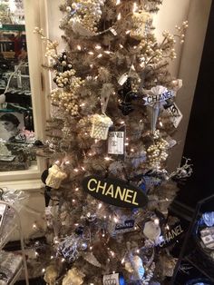 a chanel christmas tree is decorated with silver and white ornaments