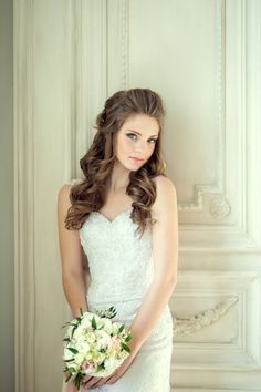 a woman in a wedding dress holding a bouquet