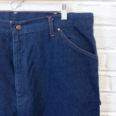 40x33 Vintage Men’s 1970s 1980s Big Mac Denim Painter Carpenter Pants Jeans For your consideration we have a pair of jeans from the ‘70s/‘80s. Made by Big Mac and done in blue denim with contrast orange stitching, these pants feature two hip pockets, watch pocket, belt loops, brass YKK zipper, two back pockets, hammer loop, and ruler pocket. These jeans seem to have seen little use in actual labor and have plenty of life left in them. Measurements;Waist- 20”Rise- 15”Thigh- 15”Inseam- 33”Leg Open Vintage Jeans With Relaxed Fit And Hip Pockets, Vintage Relaxed Fit Jeans With Hip Pockets, Retro Rigid Denim Bottoms With Belt Loops, Vintage Medium Wash Bottoms With Hip Pockets, Vintage Wide Leg Rigid Denim Bottoms, Vintage Dark Wash Bottoms With Hip Pockets, Vintage Denim Pants With Hip Pockets, 1970s Style Denim Bottoms With Pockets, 1970s Denim Bottoms With Pockets