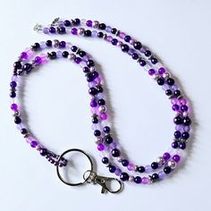 Dress up your ID holder with this Beautiful Purple Beaded Lanyard. If you wear a badge for work every day, these lanyard necklaces are a great way to brighten up your outfit.  This lanyard measures approx. 42 inches. It is made with shades of purple faux pearls, glass beads and antique silver beads. It has a swivel lobster clasp to hold your employee ID, work badge or your keys.  This lanyard is made with 49 strand Jewelry wire for maximum durability. All of my items are handmade in Prince Edwar Cheap Multicolor Beaded Lanyards, Blue Beaded Lanyard, Lanyard Accessories, Multicolor Beaded Lanyard With Key Leash, Purple Beaded Lanyard, Lanyard Badge Holder, Elegant Multi-strand Purple Beaded Necklaces, Prince Edward Island Canada, Lanyard Necklace