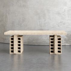 a table made out of concrete blocks with shelves on each side and one shelf in the middle