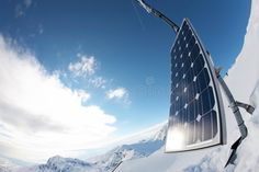 a solar panel on top of snow covered mountains