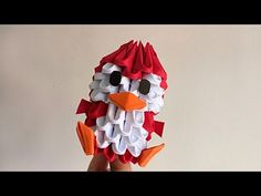 an origami bird made out of paper is held in the palm of someone's hand