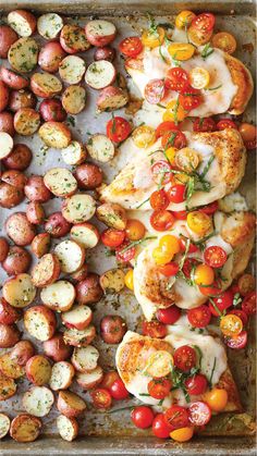 chicken, tomatoes and potatoes on a baking sheet