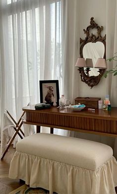 a desk with a bench and mirror in front of it