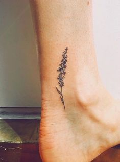 a small flower tattoo on the ankle