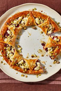 a white plate topped with pastry covered in toppings