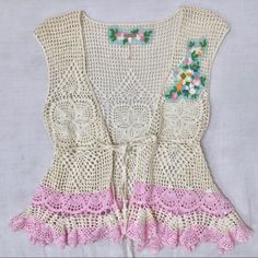 A Beautiful Vintage Buttercream Crocheted Top With A Tie Front And Peplum Waist. Decorated With Embroidered Floral And Bird Accents On The Chest And Powder Pink Along The Bottom. Would Be Super Cute With Jeans, Denim Shorts Or A Skirt. Perfect Condition, No Stains, No Pulls, Never Worn. Waist Is About 25” Across But The Fabric Has Some Give. It Is Adjustable As The Tie Is Through The Weaving Of The Fabric And Can Be Moved As Wide Or Tight As Possible. Pink V-neck Crochet Top For Spring, Feminine Crochet Top With Lace Patchwork For Spring, Feminine Lace Patchwork Crochet Top For Spring, Fitted V-neck Pink Crochet Top, Feminine Cotton Crochet Top With Crochet Trim, Fitted Crochet Top With Crochet Trim For Spring, Fitted Crochet Trim Top For Spring, Spring Vacation Crochet Top With Lace Patchwork, Spring Crochet Top With Lace Patchwork For Vacation