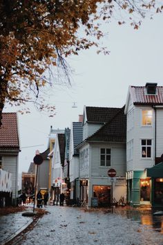 an image of people walking down the street on a rainy day in town with umbrellas