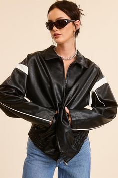 The Nisha Racer Jacket is crafted from high-quality faux leather with chic black and white colorblock contrast striped details. It features a trendy oversized baggy fit, ruched hem, and a front zipper closure for easy wearability. Stay stylish and warm in this must-have bomber jacket for this fall and winter season. Model is 5'8 wearing a size small. Fabric is 55% cotton and 45% PU. Spring Streetwear Outerwear With Contrast Panels, Trendy Outerwear With Contrast Stitching, Trendy Black Outerwear With Contrast Color, Trendy Long Sleeve Outerwear With Contrast Stripes, Trendy Fall Outerwear With Contrast Stripes, Black Outerwear With Contrast Panels For Fall, Black Fall Outerwear With Contrast Panels, Fall Outerwear With Contrast Stripes, Fall Black Outerwear With Contrast Stripes