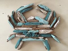 a piece of driftwood with blue and white paint on it