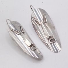 These Vintage Earrings Were Made In The 1980s And Feature A Unique Modernist Design. They Were Handcrafted From Sterling Silver By A Studio Artisan And Fashioned Into A Tribal Mask Shape. Despite Some Slight Tarnishing, They Remain In Good Condition. The Earrings Are Secured With A Hook Clasp And Weigh 11.6 Grams. Measuring 2 1/4" Long By 3/4" Wide, They Are Sure To Make A Statement With Any Outfit. Stock Code: 5bt2303-8-15 Mask Shapes, Modernist Design, Hook Clasp, The 1980s, Vintage Earrings, Face Mask, Mask, Jewelry Earrings, Women Jewelry