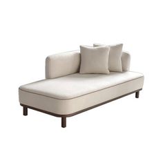 a white couch with three pillows on it's back and one arm resting against the pillow