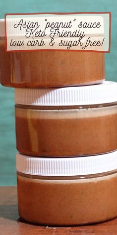 three jars of peanut sauce sitting on top of each other with the label above them