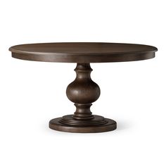 a round dining table with an oval top and pedestal base, in dark brown wood