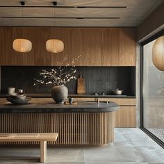 a kitchen with wooden cabinets and black counter tops next to a glass door that leads to an outside patio