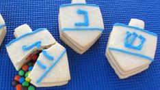 decorated cookies with letters and candy on blue mat