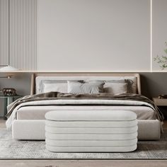 a bedroom with a large bed and white furniture