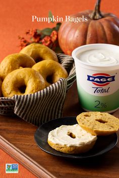 pumpkin bagels and yogurt are sitting on a tray next to an ice cream cup