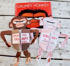 some paper cut out of monkeys and a book