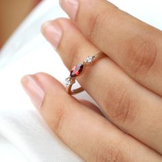 Forget regular bands, it is time to step the game up! Time to include some super beautiful gemstones like Garnet and stack unique bands or wear them on their own. Lucky ladies! Details: Center stone Gemstone: Garnet Stone Shape: Marquise Measurements: 6x3 mm Side stones Gemstone: Moissanite Shape: Round Measurements: 1.7 mm (2) Band measurements: approx. 1.8mm wide, approx. 1.5mm thick The ring is also available in solid gold. Contact us for pricing. The Giotto is available in other gemstones. Rose Gold Garnet Gemstone Ring, Rose Gold Rings With Gemstone Accents As Gift, Adjustable Rings With Gemstone Accents, Gift Rose Gold Rings With Gemstone Accents, Garnet Gemstone Accents Promise Ring, Garnet Gemstone Promise Ring, Adjustable Stackable Anniversary Rings With Stones, Adjustable Stackable Rings With Stones For Anniversary, Ruby Birthstone Ring With Gemstone Accents For Promise