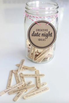 a jar filled with wooden clothes pins next to a tag that says creative date night ideas