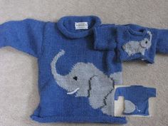 a blue sweater with an elephant on the front and two small ones in the back