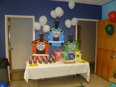 a birthday party with balloons and thomas the train decorations