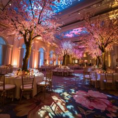 the inside of a banquet hall decorated with cherry blossom trees