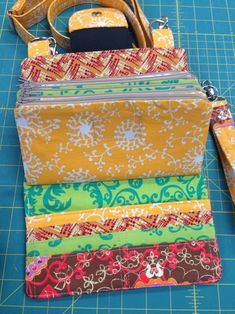 four zippered pouches sitting on top of a cutting board