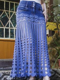 a woman is wearing a blue crochet skirt