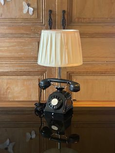 an old fashioned telephone sitting on top of a table