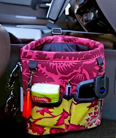 the inside of a car with a pink and yellow flowered bag in it's pocket