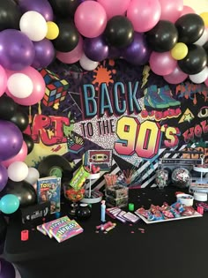 the back to the 90's party is set up with balloons and streamers