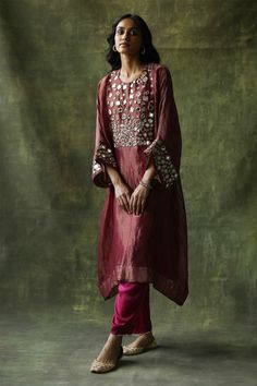 Ruby red zari silk kaftan kurta embellished with mirror work across the yoke and sleeves. Come with pants with mirror finished trims and a slip.
Component: 3
Pattern: Embroidery
Type Of Work: Mirror work
Neckline: Round
Sleeve Type: Loose sleeves
Fabric: Kurta: Zari Silk, Slip: Satin, Pant: Modal Satin
Color: Red
Other Details: 
Mirror work
Zari silk kurta
Occasion: Mehendi and Haldi - Aza Fashions Casual Bridal Dress, Kaftan Kurta, Satin Pant, Embroidery Mirror, Red Kurta, Kaftan Designs, Latest Dress Design, Kurta Dress, Bridal Dress Fashion