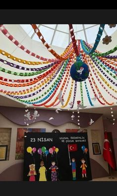 the ceiling is decorated with colorful streamers and balloons for children's birthdays