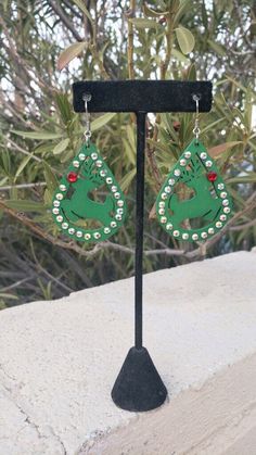 Fun and sparkly Christmas 🎄 earrings! Setting: pierced/ hook setting Color: green Material: wood Green Dangle Earrings For Holiday, Green Dangle Earrings For Holidays, Green Drop Earrings For Holiday, Green Christmas Drop Earrings Jewelry, Green Dangle Crystal Earrings For Festive Occasions, Green Holiday Drop Earrings, Holiday Green Drop Earrings, Christmas Festive Jewelry With Rhinestones, Green Holiday Earrings For Festive Occasions