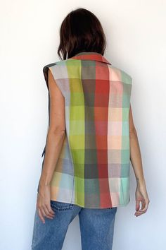 Parachute Vest from Marrakshi Life Sleeveless, open cotton vest in a rainbow plaid pattern Shawl collar, padded shoulders Two front pockets Relaxed, oversized fit 100% Cotton Hand woven in Marrakesh Model Measurements & Item Sizing: Model Height: 5'8” Model Size: US 2 / S / 26 Size shown on model: O/S Casual Plaid Vest For Spring, Multicolor Sleeveless Vest For Fall, Plaid Cotton Vest For Fall, Fall Plaid Cotton Vest, Multicolor Cotton Vest For Spring, Sleeveless Multicolor Cotton Outerwear, Multicolor Sleeveless Cotton Outerwear, Marrakshi Life, Swim Jewelry