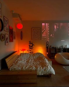 a bed room with a neatly made bed and pictures on the wall