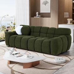 a green couch sitting on top of a rug in a living room next to a white coffee table