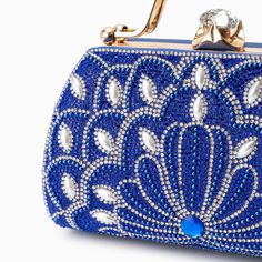 Introducing the Augustine Pearls Handbag - an enchanting masterpiece crafted to elevate your evening attire to unprecedented levels of sophistication. This clutch exudes magnificence in every detail, adorned with shimmering rhinestones and delicate pearl accents. Remarkably lightweight, it guarantees seamless carrying all through the night without compromising on style. Now available in blue, black, silver, and red. Glamorous Pearl-embellished Evening Bag For Events, Embellished Party Clutch Evening Bag, Embellished Clutch Evening Bag For Party, Pearl-embellished Evening Bag, Pearl Embellished Evening Bag, Elegant Blue Bag With Pearl Handle, Bedazzled Rectangular Evening Bag For Parties, Glamorous Pearl-embellished Evening Bag, Embellished Clutch For Party