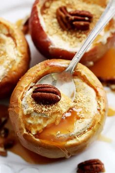 baked apples with caramel and pecans on a white plate, ready to be eaten